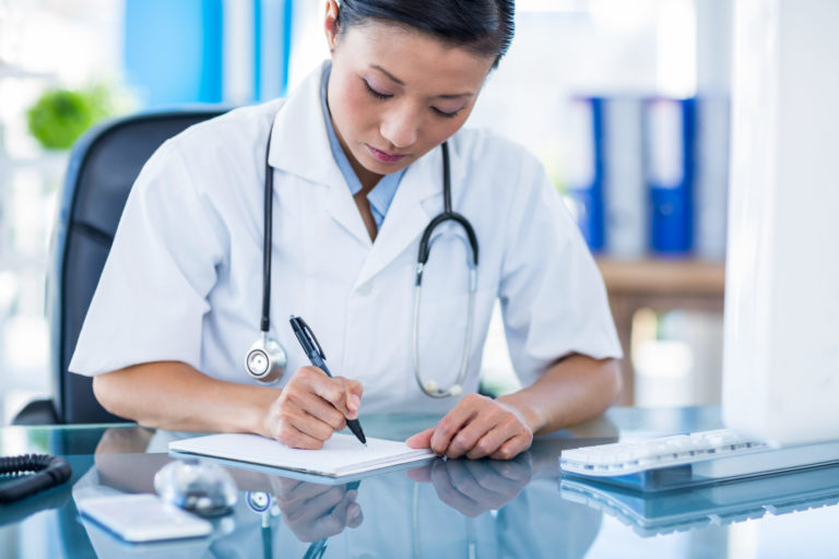 a doctor looking at a tablet
